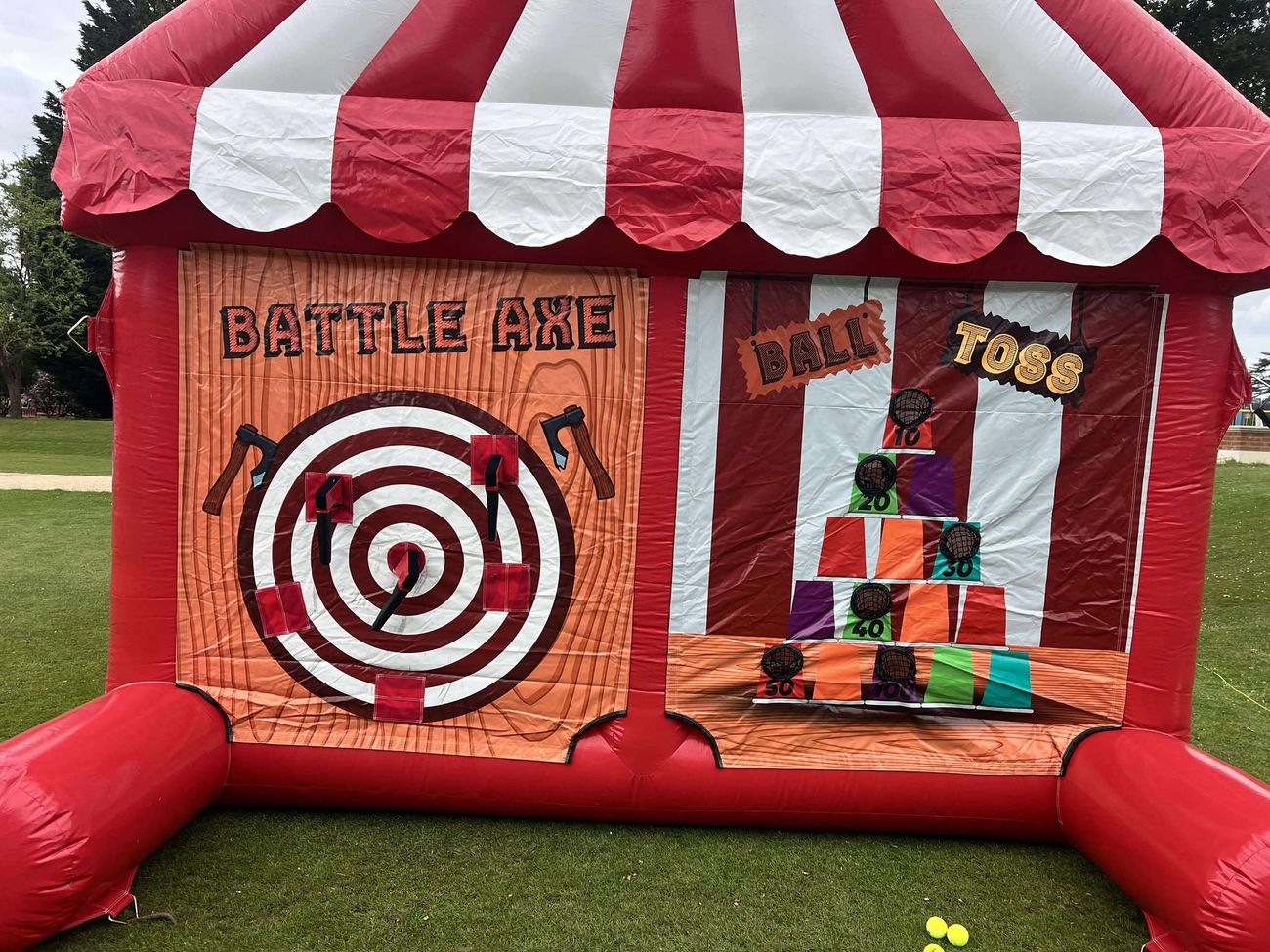 Battle axe velcro axe-throwing target next to the knock-down ball toss game