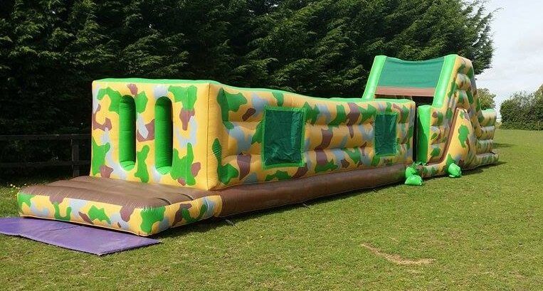 Full length view of the 50ft army assault course on a grass field
