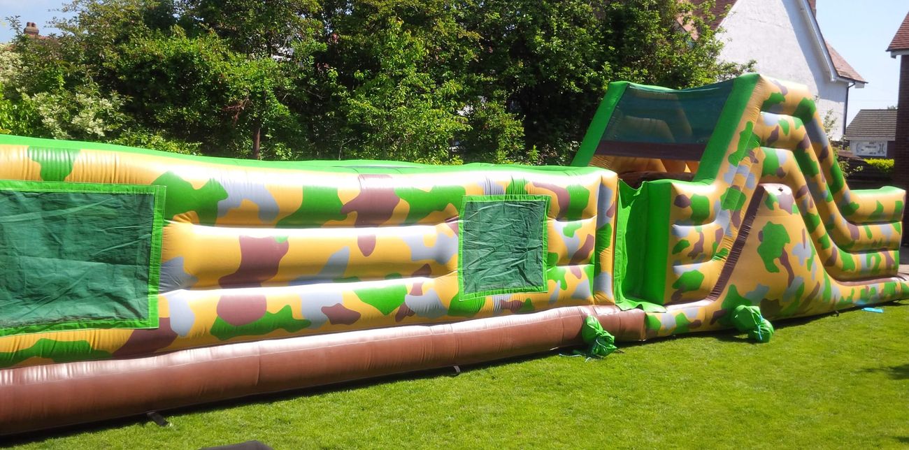 Side view showing green mesh windows and slide on the army assault course