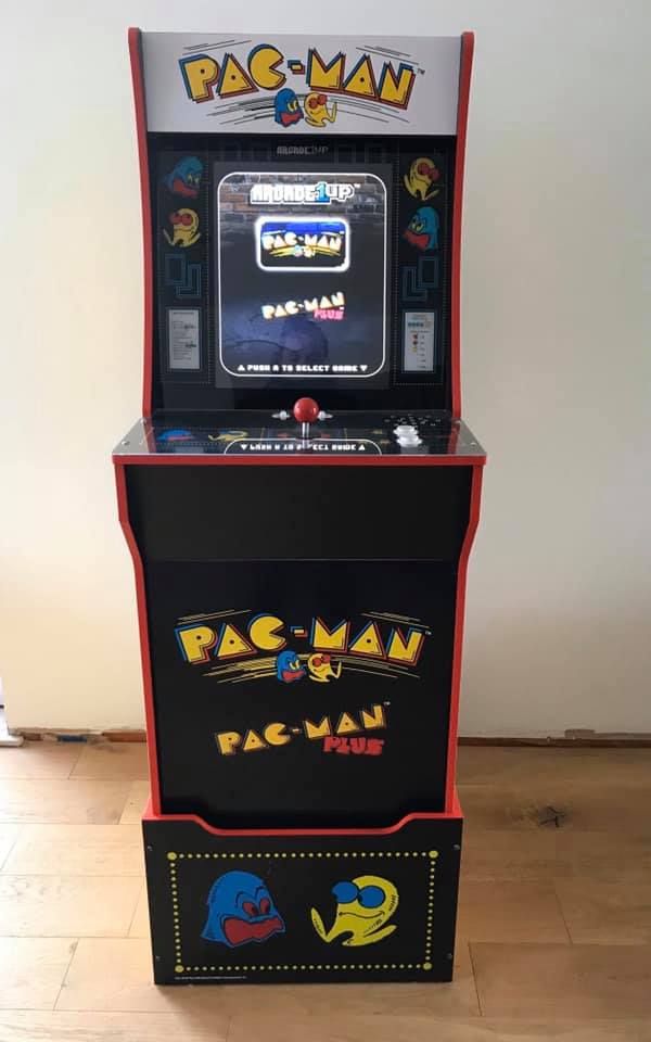 Arcade1Up Pac-Man upright cabinet showing the game-selection menu