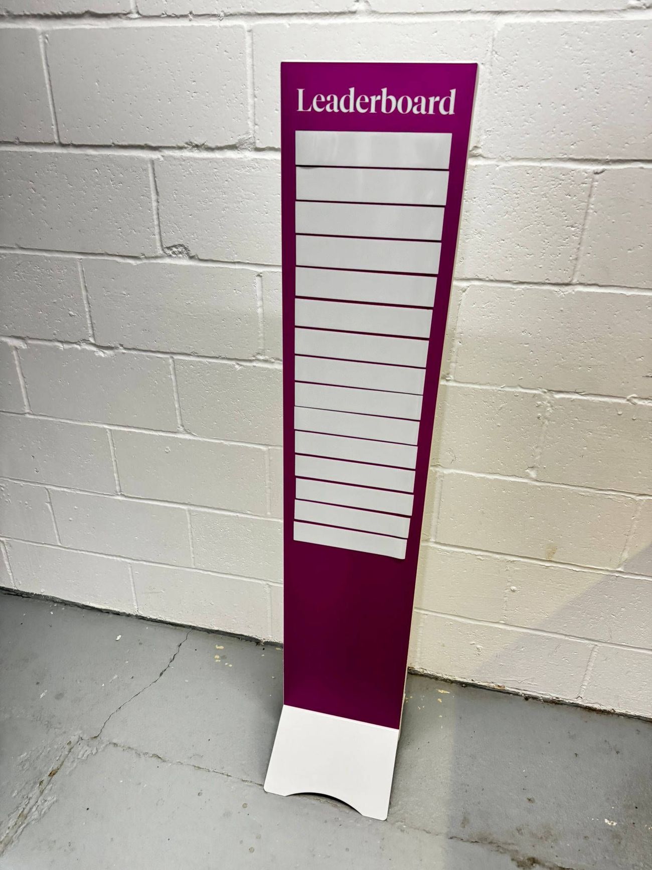 Magenta leaderboard with blank write-on strips on a curved base, header reading Leaderboard