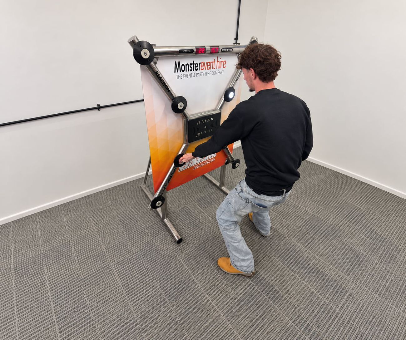 Team member playing the Monster-branded Batak Lite reaction wall