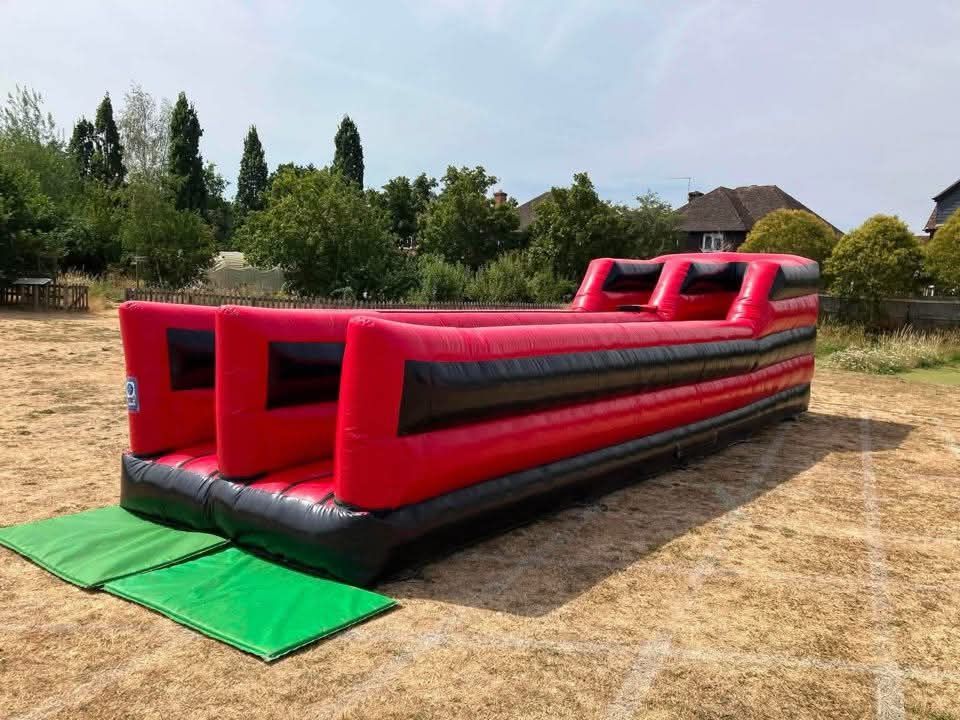 Front view of the bungee run with green crash mats laid out at the two lane entrances