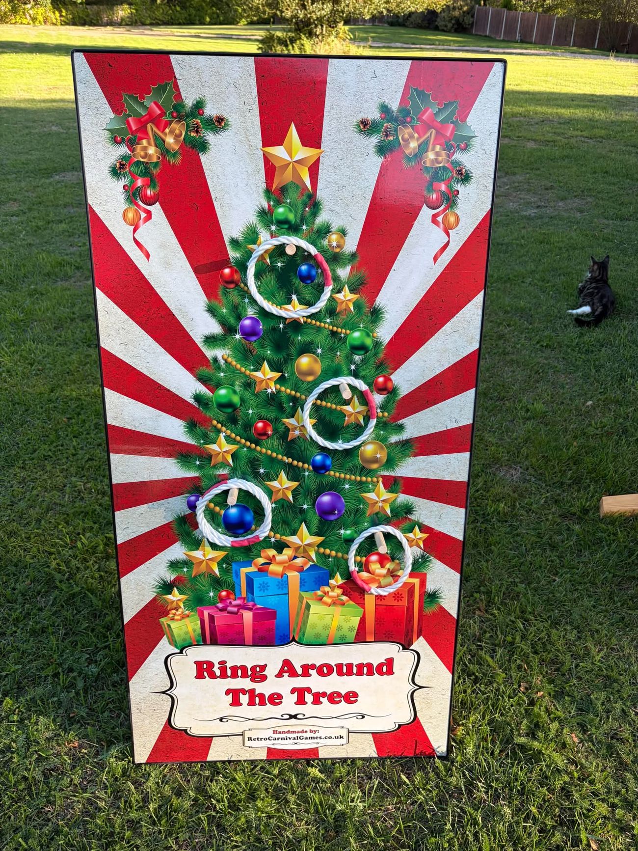 Ring Around the Tree board with rope rings looped over the pegs of an illustrated Christmas tree