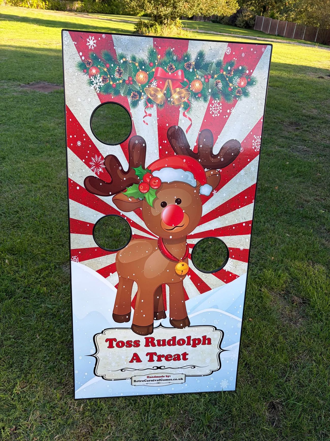 Toss Rudolph A Treat Christmas board with three beanbag holes in a cartoon reindeer design