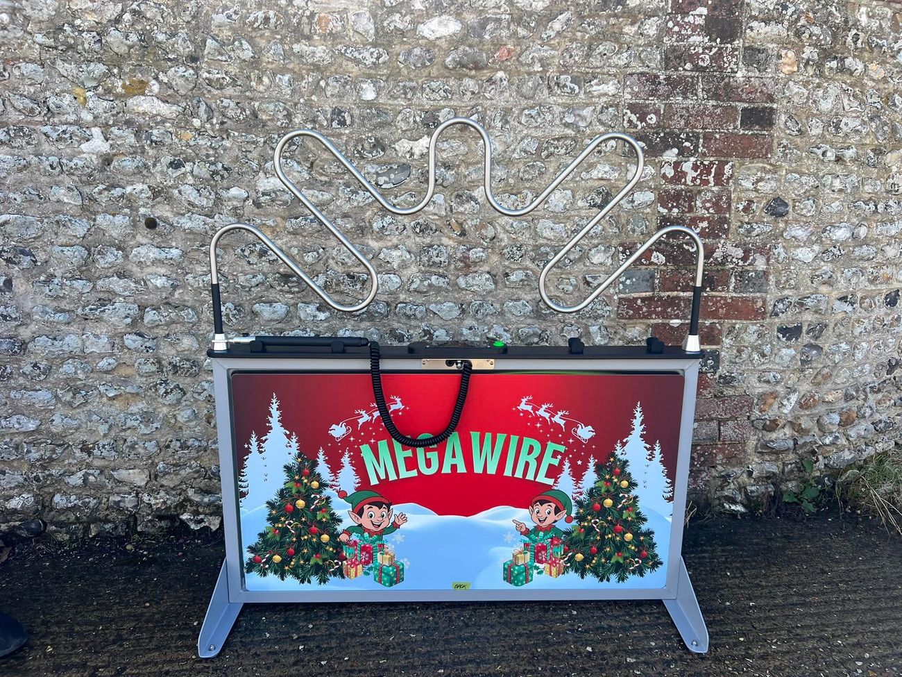 Christmas-themed Mega Wire steady hand game set up outdoors