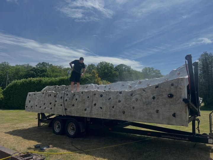 Climbing wall sections on their trailer being pressure washed behind the Havant workshop before the next event