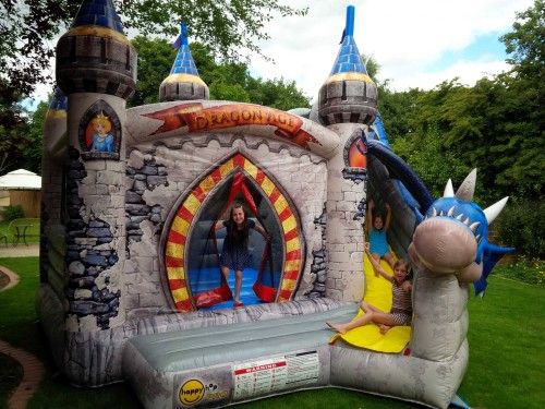 Dragon bouncy castle front view with side slide under the wing