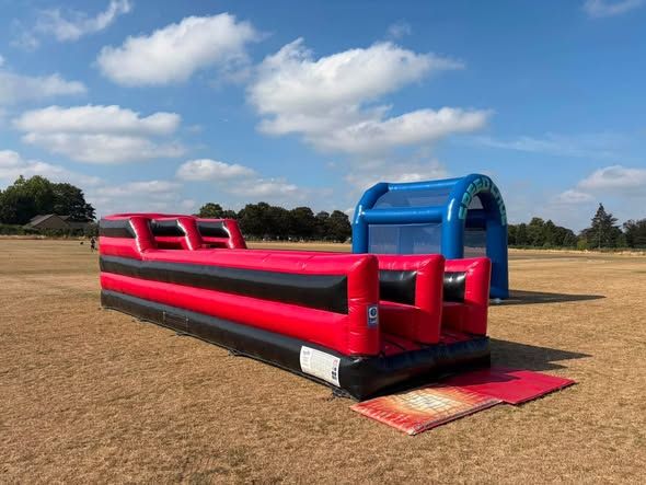 Inflatable team building games set up on a field in Twickenham