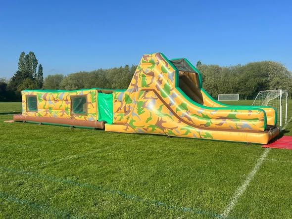 Camouflage army assault course with a slide on a sports field in London