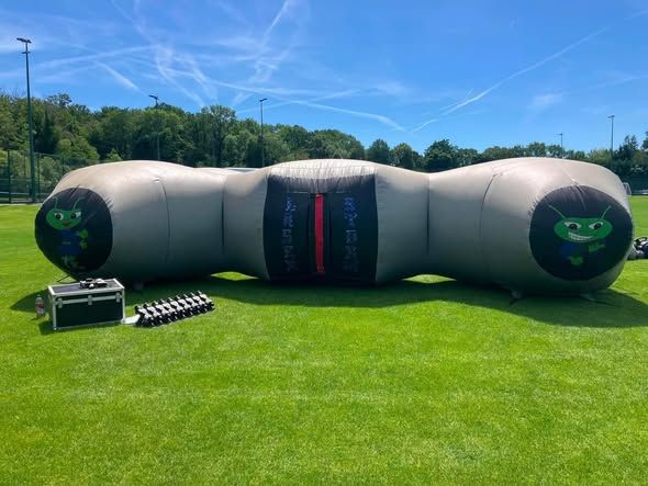 Large inflatable activity on a school field in Surrey