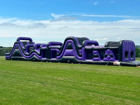 Inflatable assault course on a school field in Winchester