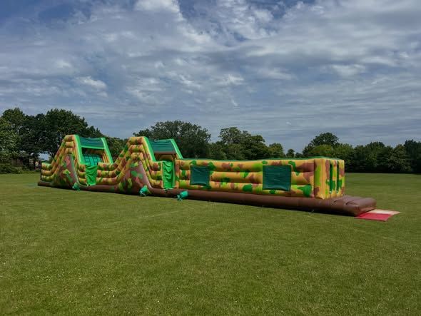 Inflatable school sports day activity set up on grass in Woking
