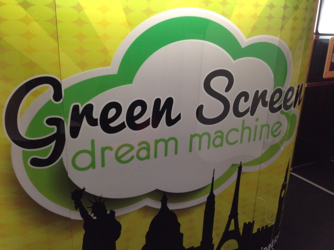 Green Screen Dream Machine logo on the booth with world landmark silhouettes