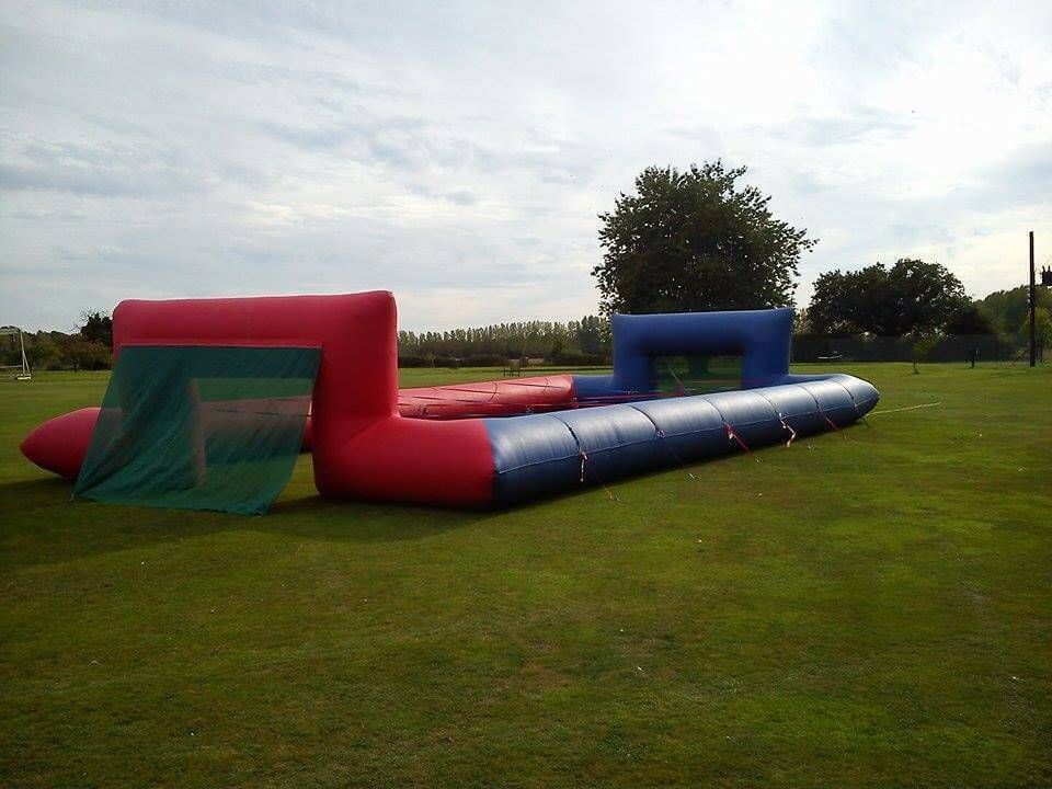 The full ropes pitch set up empty on grass with a goal and green net at each end