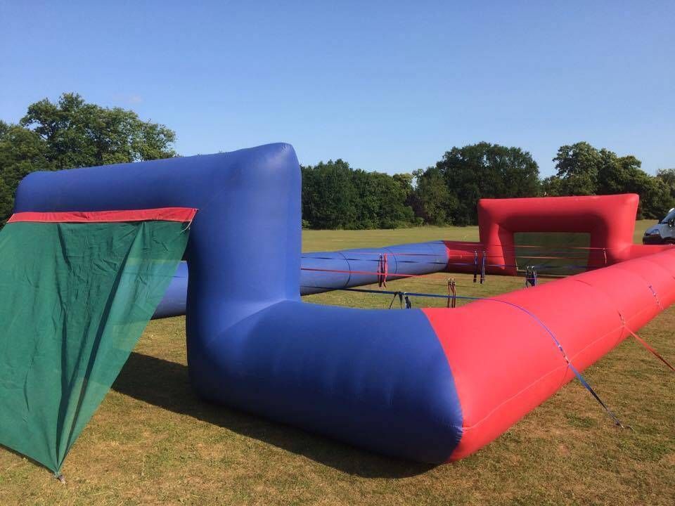 Close-up of the blue and red inflatable goals with green netting and the ropes across