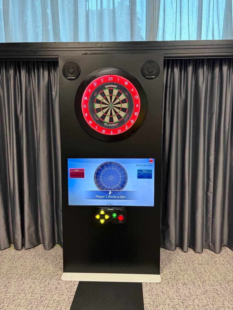 Black interactive dartboard cabinet with Winmau board, LED surround and player screen