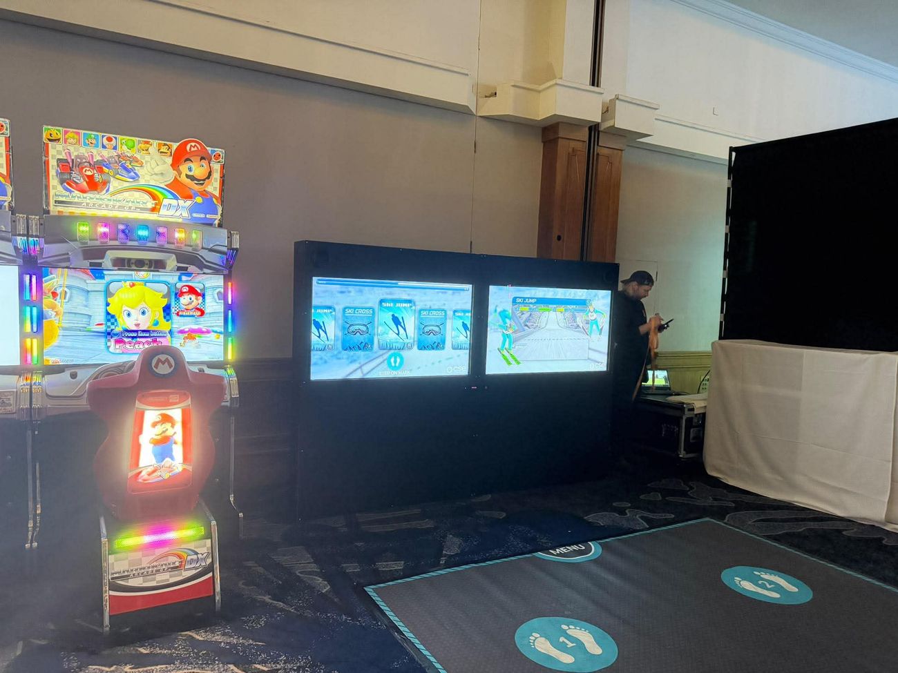iWall ski jump game on the twin screens at an event, with the floor mat in front