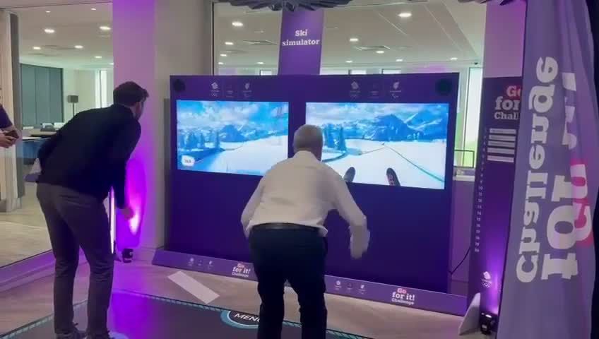 iWall ski simulator: two players on the floor mats in front of the twin screens