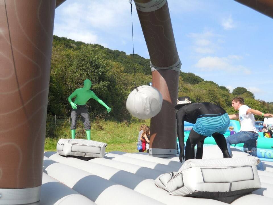 The padded ball swinging between players at an outdoor festival fun day