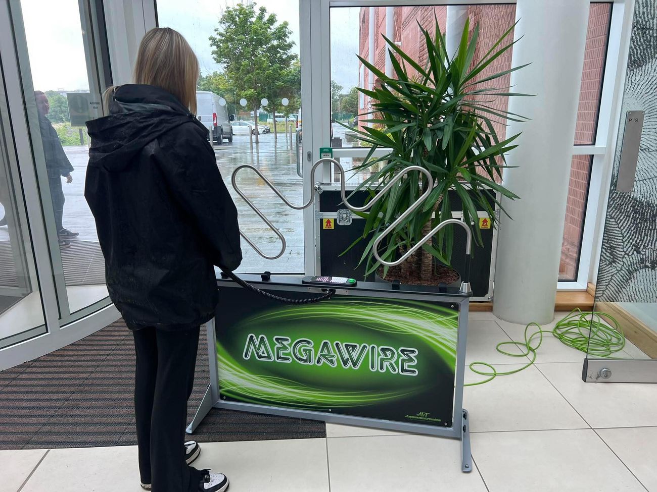 Player guiding the ring along the Mega Wire steady hand game