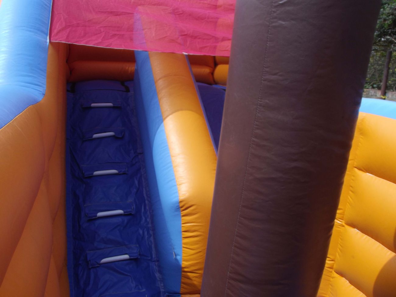 Padded climbing steps inside the pirate ship inflatable leading up to the slide