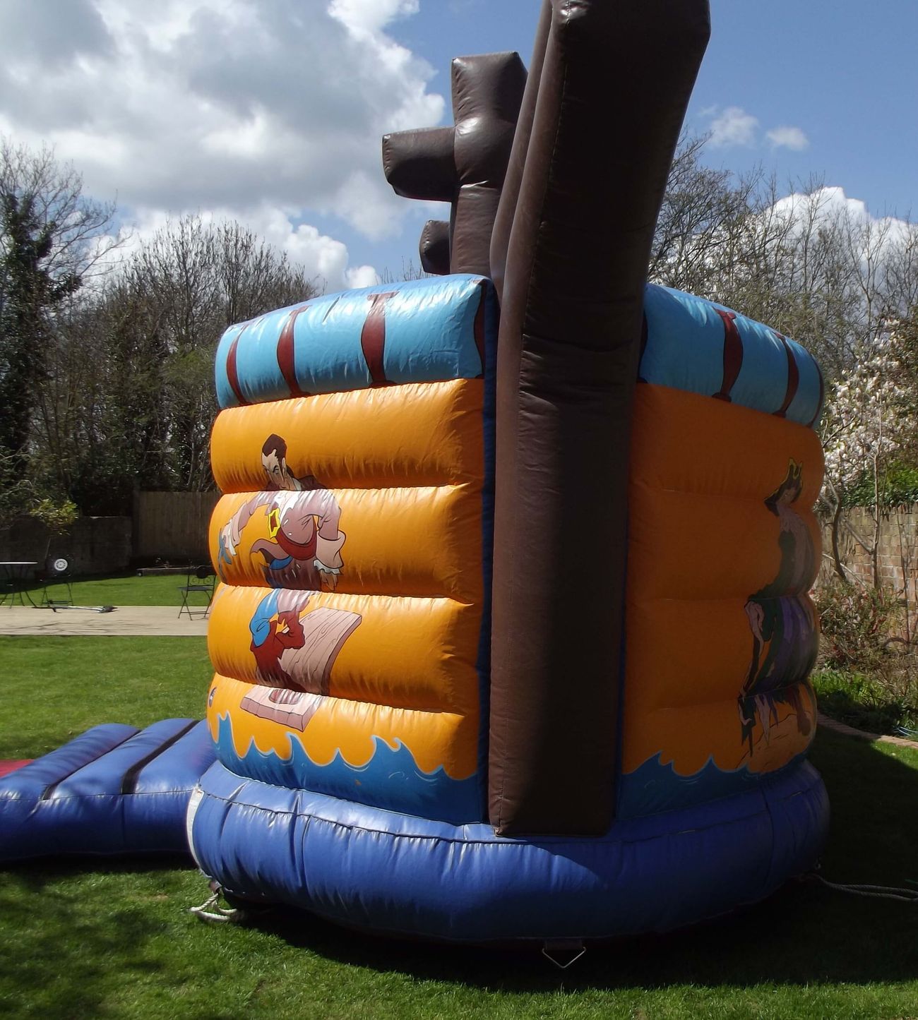 Rear of the pirate ship inflatable showing the brown mast and pirate artwork