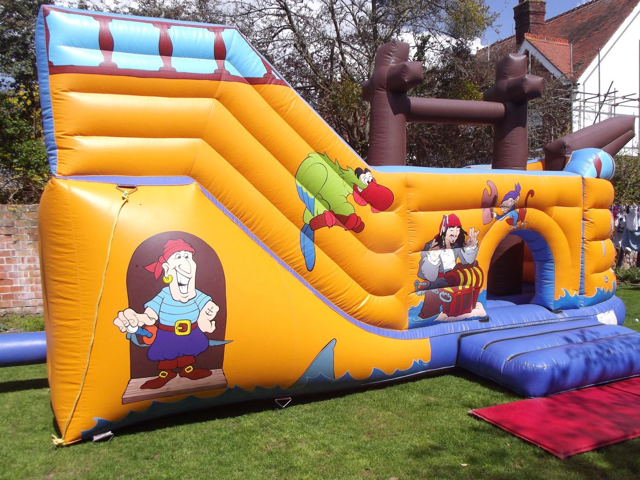 Pirate ship inflatable slide and arched entrance with a cartoon pirate captain