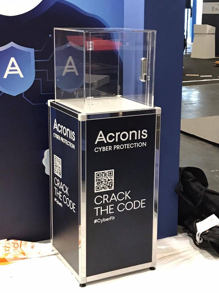 Prize vault on an exhibition stand with printed podium panels and a QR code