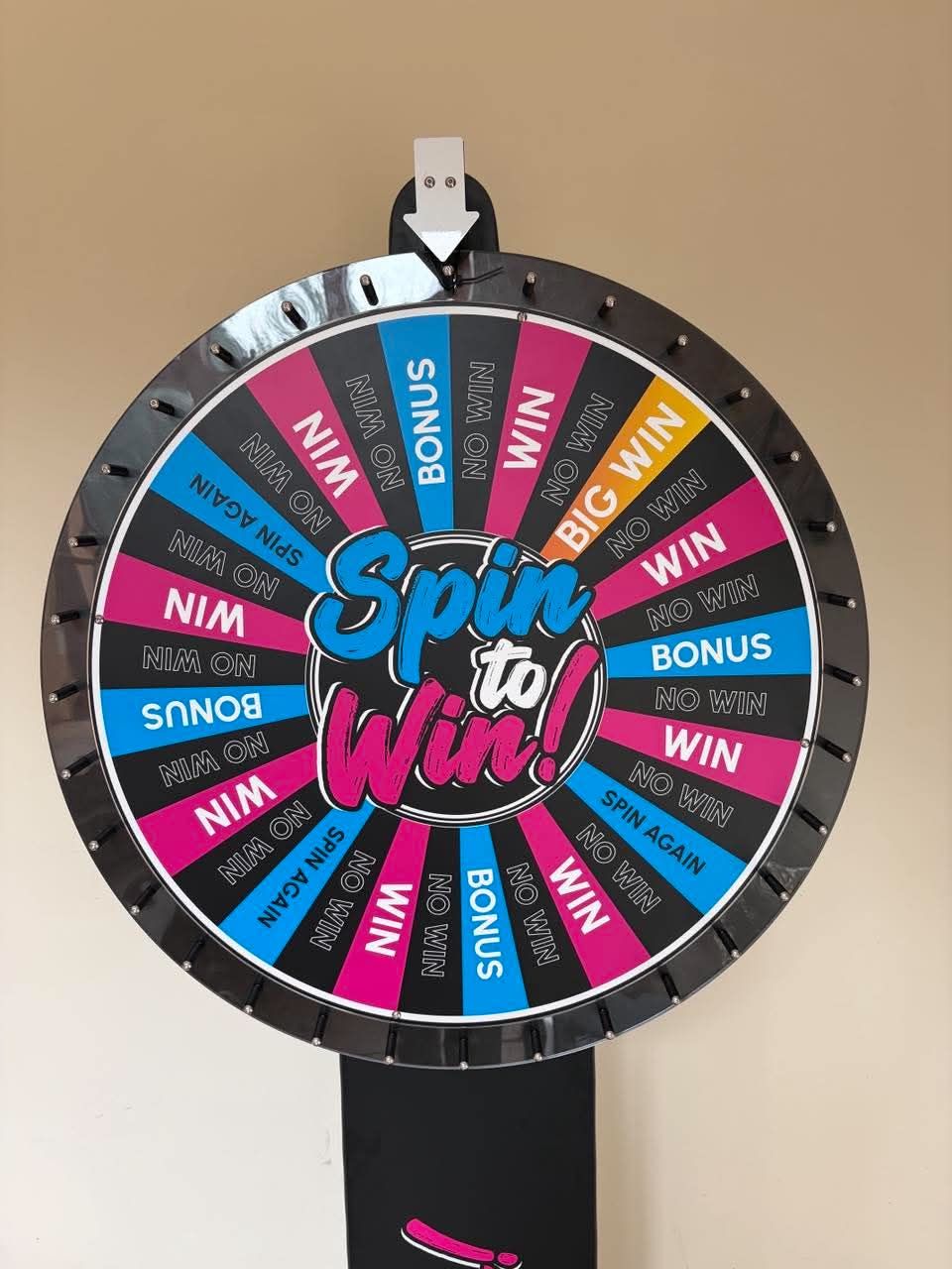Close-up of the Spin to Win wheel face with WIN, NO WIN, BONUS, SPIN AGAIN and BIG WIN segments