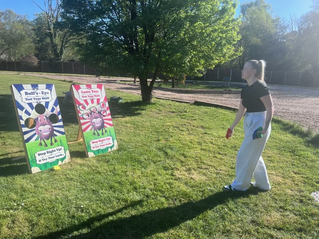 Bull's Eye and Lasso Toss games set up on grass