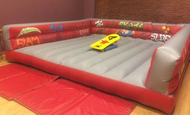 Indoor skateboard simulator with graffiti walls, grey bed and yellow board
