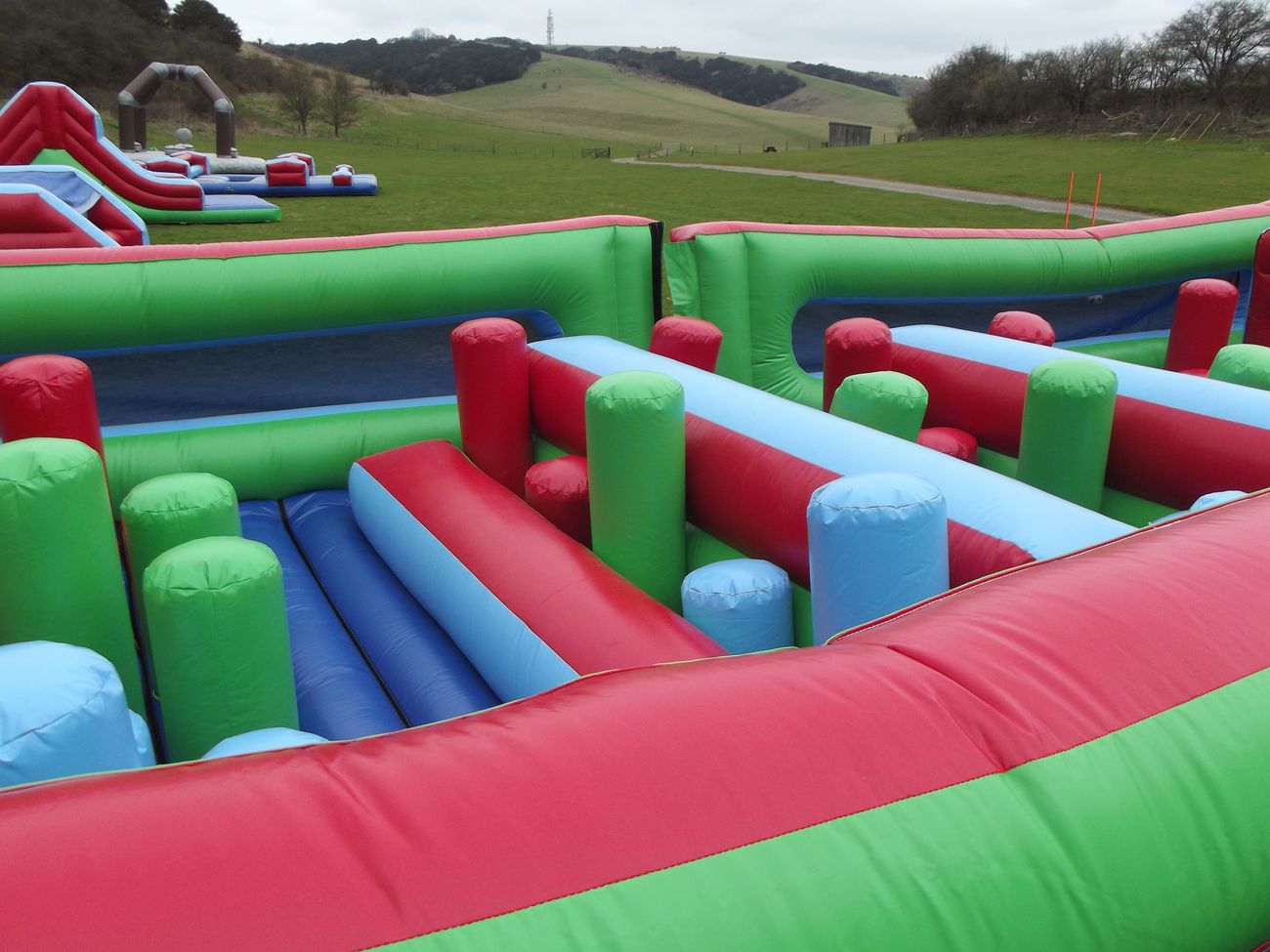 Looking down the lanes of inflatable pillars and rollers inside the Challenger course