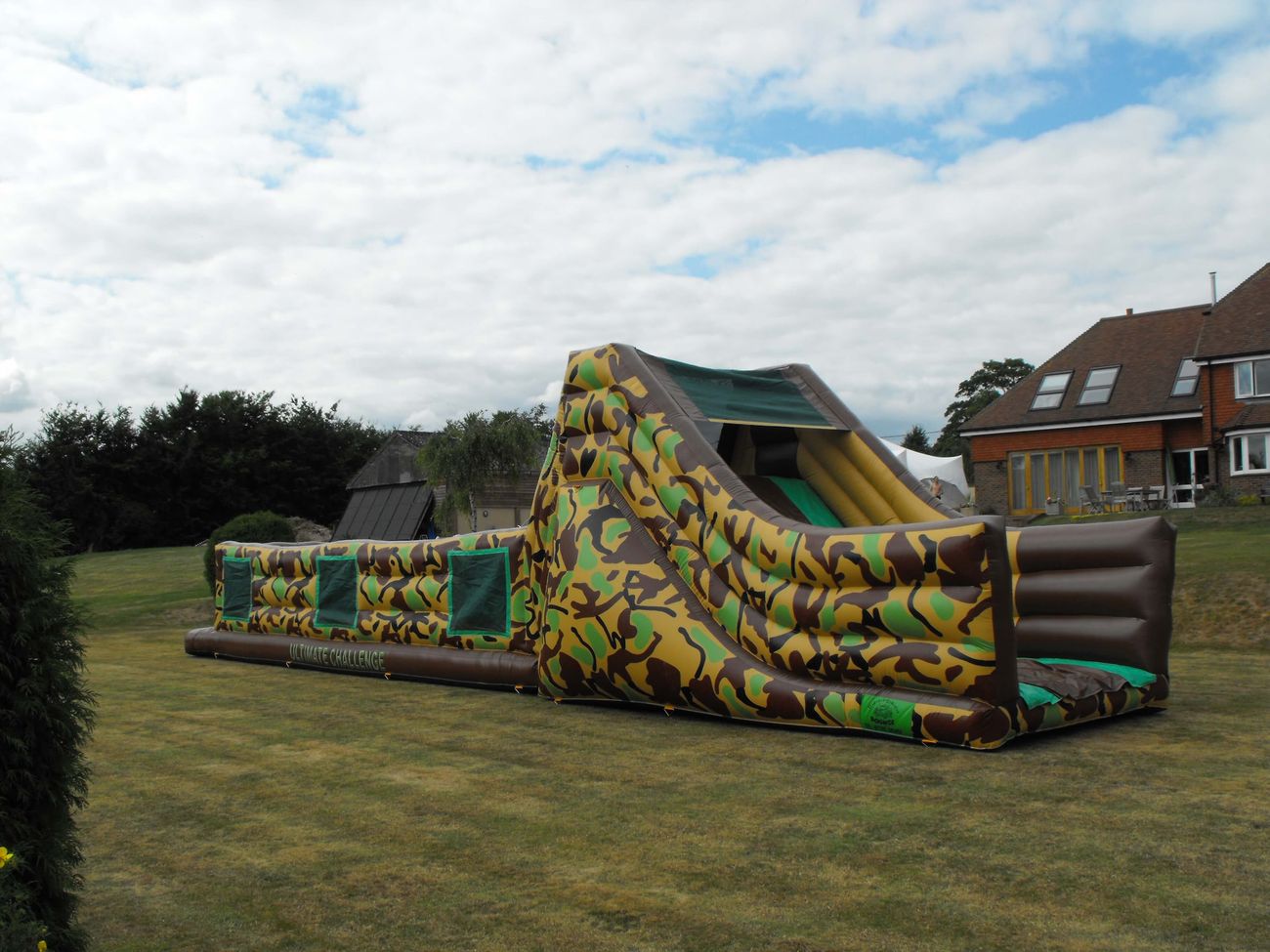 60ft army assault inflatable course in the backgarden of a house