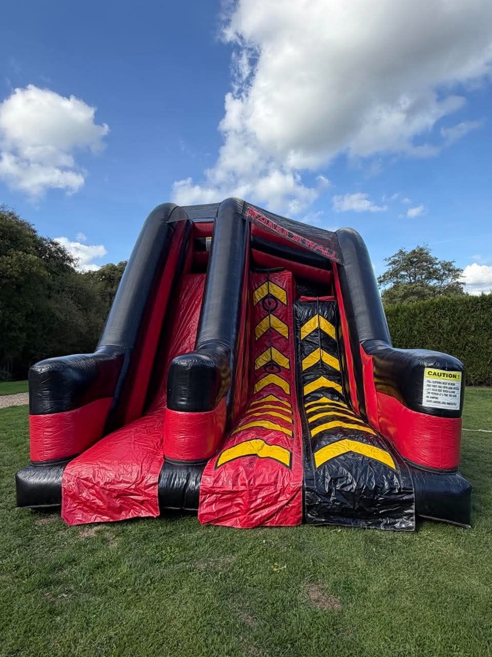 Full front view of the Warrior Wall, two chevron climbing lanes and the centre slide