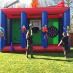 two boys throwing a basketball and a giant dart on the 3-in1 sports inflatable game