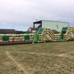 86ft inflatable army assault course in a field