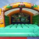 green and yellow wild animal themed bouncy castle
