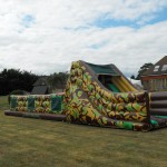 60ft army assault inflatable course in the backgarden of a house