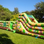 50ft army inflatable assault course in front of trees