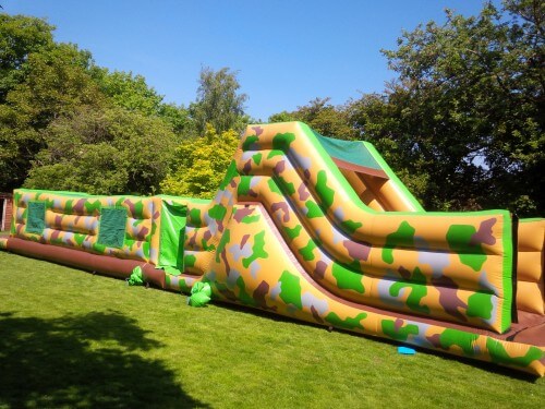 50ft army inflatable assault course in front of trees